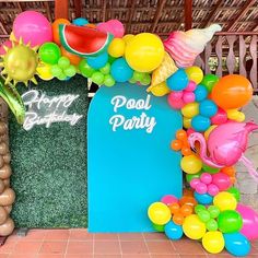 there is a pool party decorated with balloons