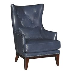 an upholstered blue leather chair with wooden legs and nailing on the armrests