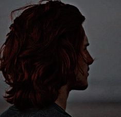 a man with red hair is staring at something