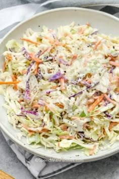 a white bowl filled with coleslaw and carrots