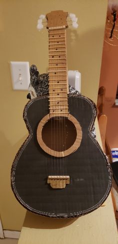 an acoustic guitar sitting on top of a table