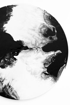 a black and white photo of the earth as seen from space on a circular plate