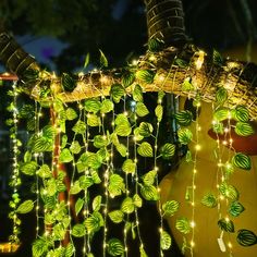 a string of lights hanging from the side of a tree next to a yellow rubber duck