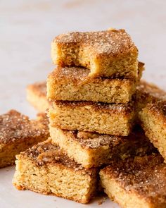 a pile of sugary brownies sitting on top of a white plate