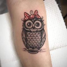 an owl with a red bow on its head is shown in this tattoo style photo