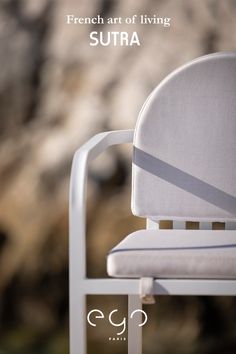 a white chair sitting on top of a sandy beach