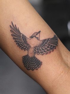 a bird tattoo is shown on the arm