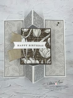 a card with flowers on it and a tag that says happy birthday in the center