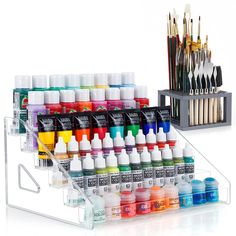 an assortment of acrylic paints and brushes on display