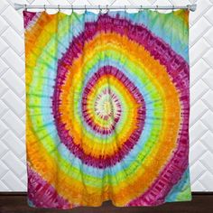 a multicolored tie - dyed shower curtain hangs in front of a white wall