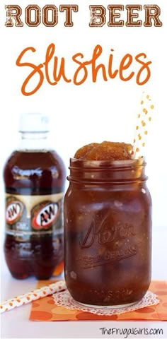 two jars filled with root beer slushies on top of a table