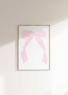 a white wall with a pink bow on it