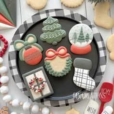 decorated cookies on a plate with holiday decorations