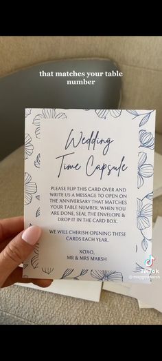 someone holding up a wedding card with the words, wedding time capsule written on it