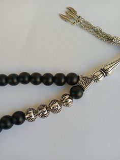 Onyx Tasbih Custom Name with Matte Black Stone Round Prayer Beads, Personalized Rosary Islamic Gift, Muslim Prayer Beads, Masbaha, Subha, Eid Qurban Gift For Other Products: https://www.etsy.com/shop/TesbihFactory Main Material Used in Making the Product: Onyx Gemstone Production Method: Workshop Weight: ± 38 g Grain Shape: Globe Cut Grain Length: 8 mm (0,32 Inches) Grain Width: 8 mm (0,32 Inches) Length Including Imam: 14 cm (5,51 Inches) Tassel Length: 7 cm (2,76 Inches) Total Length: 24 cm (9 Traditional Black Beaded Chain, Spiritual Black Beads With Silver Accents, Traditional Black Rosary With 8mm Beads, Traditional Black Rosary As Gift, Tasbih Photography, Rosary Islamic, Personalized Rosary, Mala Meditation, Prayer Bracelet