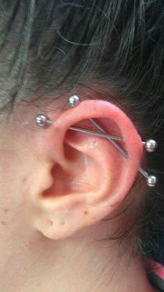 an ear with three piercings attached to it