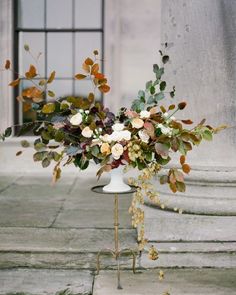 a vase filled with flowers sitting on top of a table