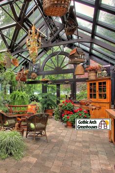 the inside of a greenhouse with lots of potted plants and hanging baskets on the ceiling