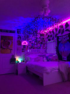 a bed room with a neatly made bed and purple lights on the ceiling above it