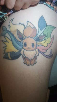 the back of a woman's thigh with pokemon tattoos on it