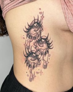 a woman's stomach with an artistic tattoo design on the side and her lower back