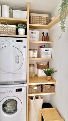 a washer and dryer in a small room with shelving on the wall