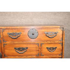 an old wooden dresser with metal handles and knobs