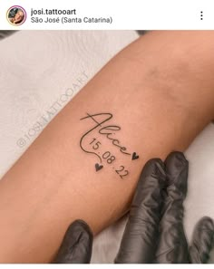 someone is getting a tattoo on their arm that says love and has hearts in it