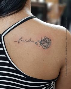 a woman with a rose tattoo on her upper arm and the word love written in cursive writing