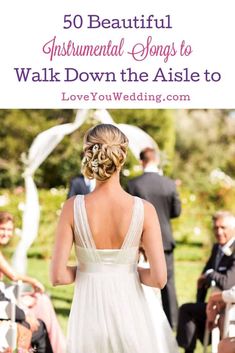 the back of a bride's dress as she walks down the aisle