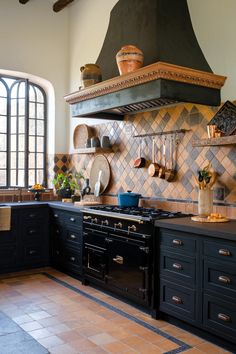 a stove top oven sitting inside of a kitchen