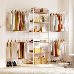 an organized closet with clothes and shoes hanging on the racks, along with other items