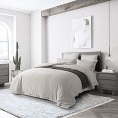 a bedroom with white walls and wooden floors