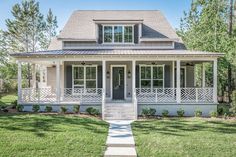 a small white house with porches on the front and side walk leading up to it