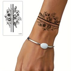 a woman's wrist with a flower tattoo on it and a white ball in the middle