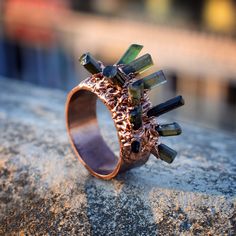 GemFormingStudio D E T A I L S Tourmaline Ring | Rough Stone Ring | Statement Ring | Gemstone Ring | Copper Ring | Stackable Ring | Ring For Women | Handmade Ring | Gift Stone MM : 7 X 4 MM ( Approx ) Ring Size : (See all the variations) Weight : 5.35 gm Color : Green Color Material : Brass Polish : All Polish Available . Contact us for wholesale prices. R I N G S https://www.etsy.com/in-en/shop/GemFormingStudio?section_id=22783374 B E A D S https://www.etsy.com/in-en/shop/GemFormingStudio?secti Unique Green Copper Ring, Unique Green Copper Rings, Brass Jewellery Handmade, Rough Stone Ring, Rock Rings, Multi Gemstone Ring, Minimal Ring, Pink Tourmaline Ring, Copper Ring