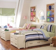 a bed room with a neatly made bed and dressers