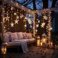 a patio covered in christmas lights and decorated with stars