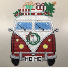 a cross stitch pattern of a vw camper van with christmas decorations on top