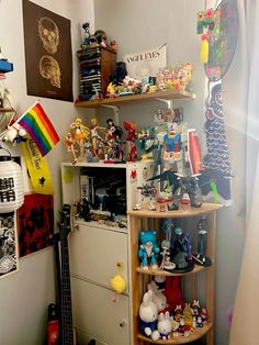 a room filled with lots of toys and clutter on top of shelves next to a window