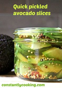 pickled avocado slices in a mason jar with text overlay that reads quick pickled avocado slices