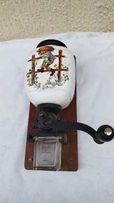 an old fashioned telephone is sitting on a wooden stand with a white cover over it