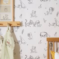 a baby's room with winnie the pooh wallpaper