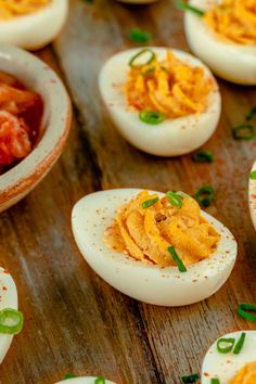 several deviled eggs are arranged on a wooden table