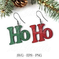 christmas earrings with the word hoo in red, green and silver glitter on them