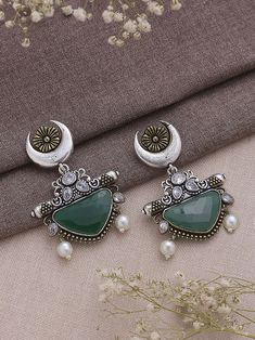 Dive into the realm of sophistication and charm with our Dual Tone Green Chandbali Earrings, a harmonious blend of tradition and contemporary flair. These earrings boast a graceful design adorned with exquisite half-moon detailing, showcasing the artisanal finesse that makes them a true embodiment of elegance. The dual tone green color palette imparts a refreshing and playful vibe, making them a versatile accessory that effortlessly transitions from day to night, from casual gatherings to festive celebrations. Meticulously crafted with precision, these earrings not only serve as a visual delight but also symbolize a timeless statement piece. Elevate your style effortlessly as you embrace the fusion of classic and modern aesthetics, allowing these Dual Tone Green Chandbali Earrings to becom Oxidised Jewelry, Pakistani Jewellery, Oxidized Earrings, Gold Schmuck, Green Moon, Half Moon Earrings, Jewellery Wedding, Fancy Jewellery Designs, Chandbali Earrings