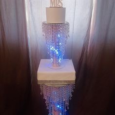 a three tiered cake with blue lights on it