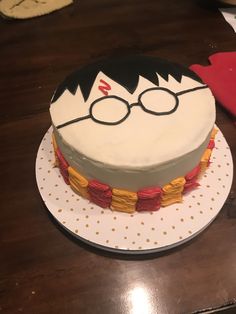 a birthday cake with a harry potter face on it's side and glasses on top