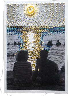 two people sitting next to each other on a beach under a full moon and water