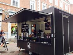 an outdoor food cart on the side of a street